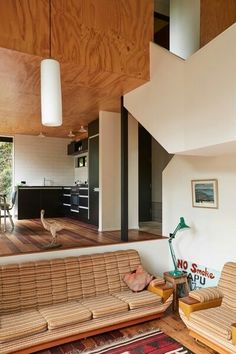 a living room filled with furniture next to a wooden floor covered in lots of windows