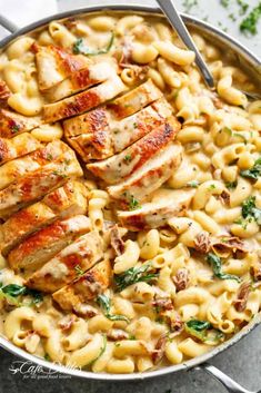 a skillet filled with chicken and pasta