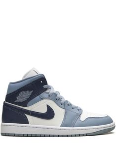 The Air Jordan 1 Mid sneakers feature a paneled design with the signature Jumpman logo patch at the tongue. These lace-up sneakers have a perforated toebox, a round toe, the signature Swoosh logo detail, and the signature Air Jordan Wings logo. The branded insole and Air cushioning ensure comfort, while the rubber outsole provides traction. Blue Air Jordan 1, Jordan Air 1, Jordan Wings, Blue Jordans, Blue Air, Nike Air Jordan 1 Mid, Jumpman Logo, Jordan Air, Wings Logo