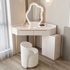 a white vanity table with a stool and mirror