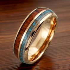 a wedding ring with wood and turquoise inlays