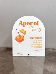 an orange cocktail sign on a table with the words apricot party written below it