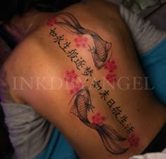 a woman with a tattoo on her back has two koi fish in the water