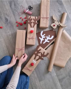 someone is wrapping presents on the floor with reindeers and reindeer antlers around them