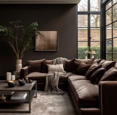 a living room filled with lots of brown furniture