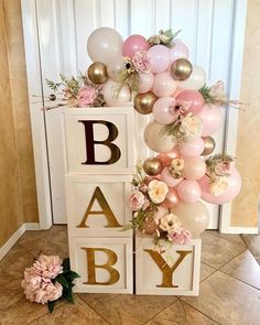 a baby shower with balloons and flowers on it