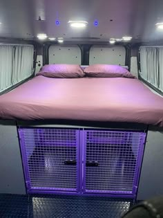 a purple bed in the back of a van