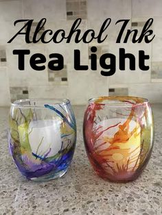 three different colored glasses sitting on top of a counter next to the words alcohol ink tea light