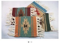 three multicolored rugs with fringe on them