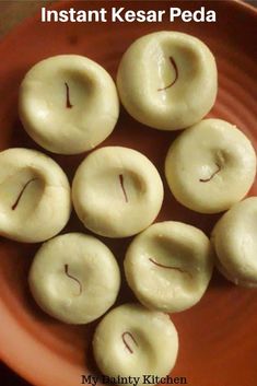 eight doughnuts in a bowl with the words instant kesar peda written on them