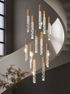 a chandelier hanging from the side of a spiral staircase