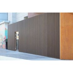 a building with wooden slats on the side of it's wall and door