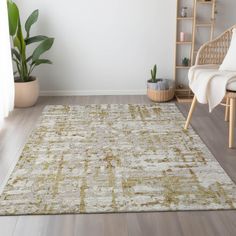 a living room with white walls and wooden floors, an area rug is on the floor