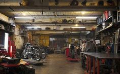 the inside of a motorcycle shop filled with lots of tools and equipment on shelves,