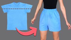 a woman wearing blue shorts and a t - shirt with an arrow cut out on it