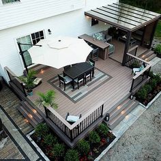 an aerial view of a deck with patio furniture and umbrellas on it's sides