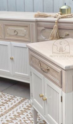 a white dresser with drawers and gold handles