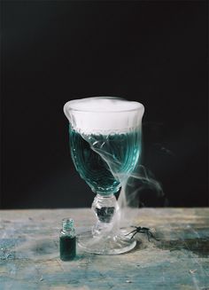 an empty wine glass sitting on top of a wooden table