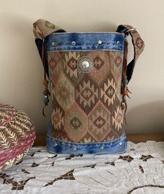 a purse sitting on top of a bed next to a pillow