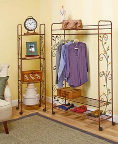 a living room with a couch, chair and clothes rack