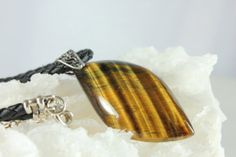 a tiger's eye stone sitting on top of a white rock