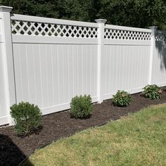 a white fence in the middle of a yard