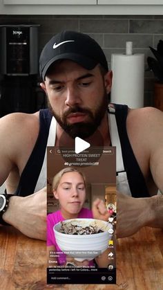 a man sitting at a table with a bowl of food in front of his face