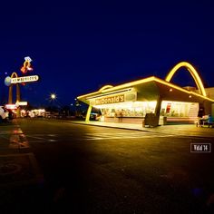 a mcdonald's lit up at night with the lights on