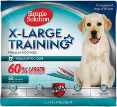 a dog sitting in front of a pack of training pads with the words x - large