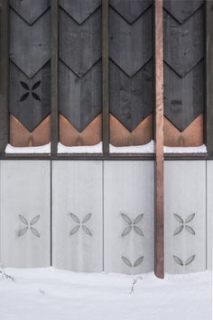 an image of a building that has snow on the ground and metal bars in front of it