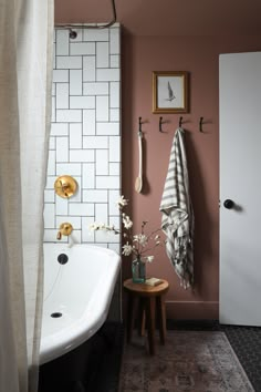 a bathroom with pink walls and white tiles