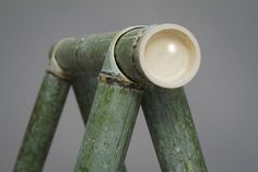 a close up of a green wooden structure with a white cup on it's top