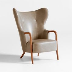 an upholstered leather chair with wooden legs and arm rests on a white background