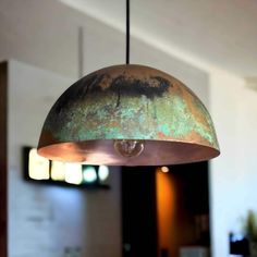 an old rusty light hanging from a ceiling