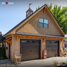 a large garage with two doors and a clock tower on the top of it's roof