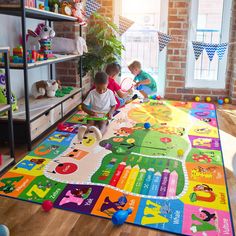 two young children playing on a colorful rug