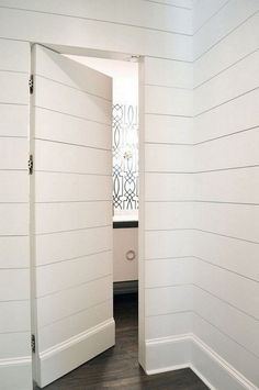 an open door leading into a white room