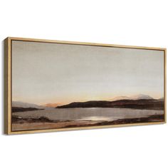 a painting hanging on the wall above a white wall with a lake and mountains in the background