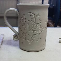 a white mug sitting on top of a counter