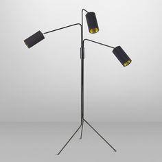 a black floor lamp with two lamps on it and one light on the side,