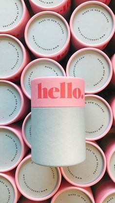 a pile of pink and white cups with the word hello printed on it's side