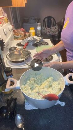 a woman mixing food in a large bowl