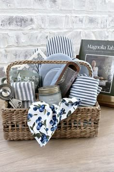 a basket filled with items sitting on top of a wooden table next to a book