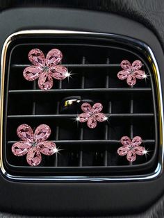 pink flowers on the front grill of a car