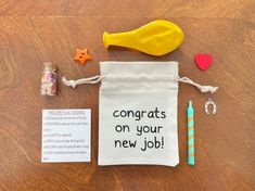 a bag with congratulationss on your new job written on it next to other items