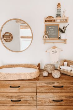 a wooden dresser topped with lots of drawers next to a mirror and wall mounted shelf