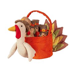 a stuffed duck sitting next to a basket filled with toys on top of a white surface