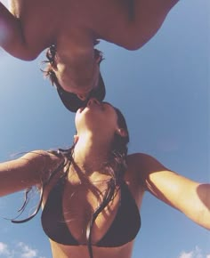 two women in bikinis standing next to each other