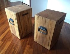 two wooden boxes sitting on top of a hard wood floor next to eachother