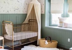 a baby's room with a crib, bed and window